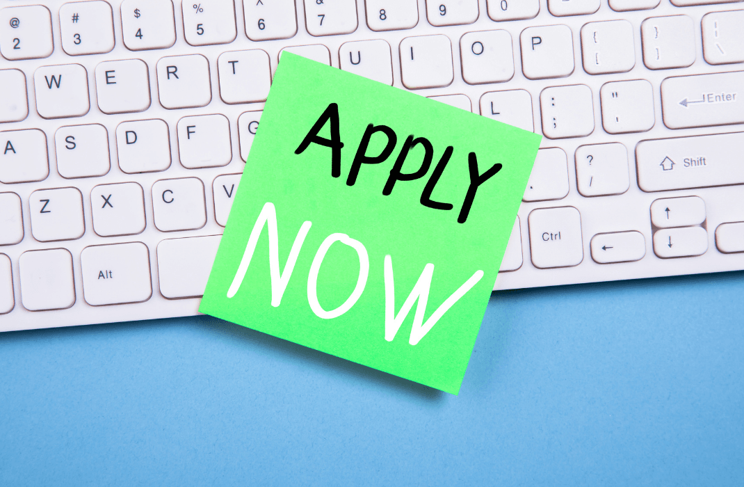Image of a keyboard with a note that says apply now