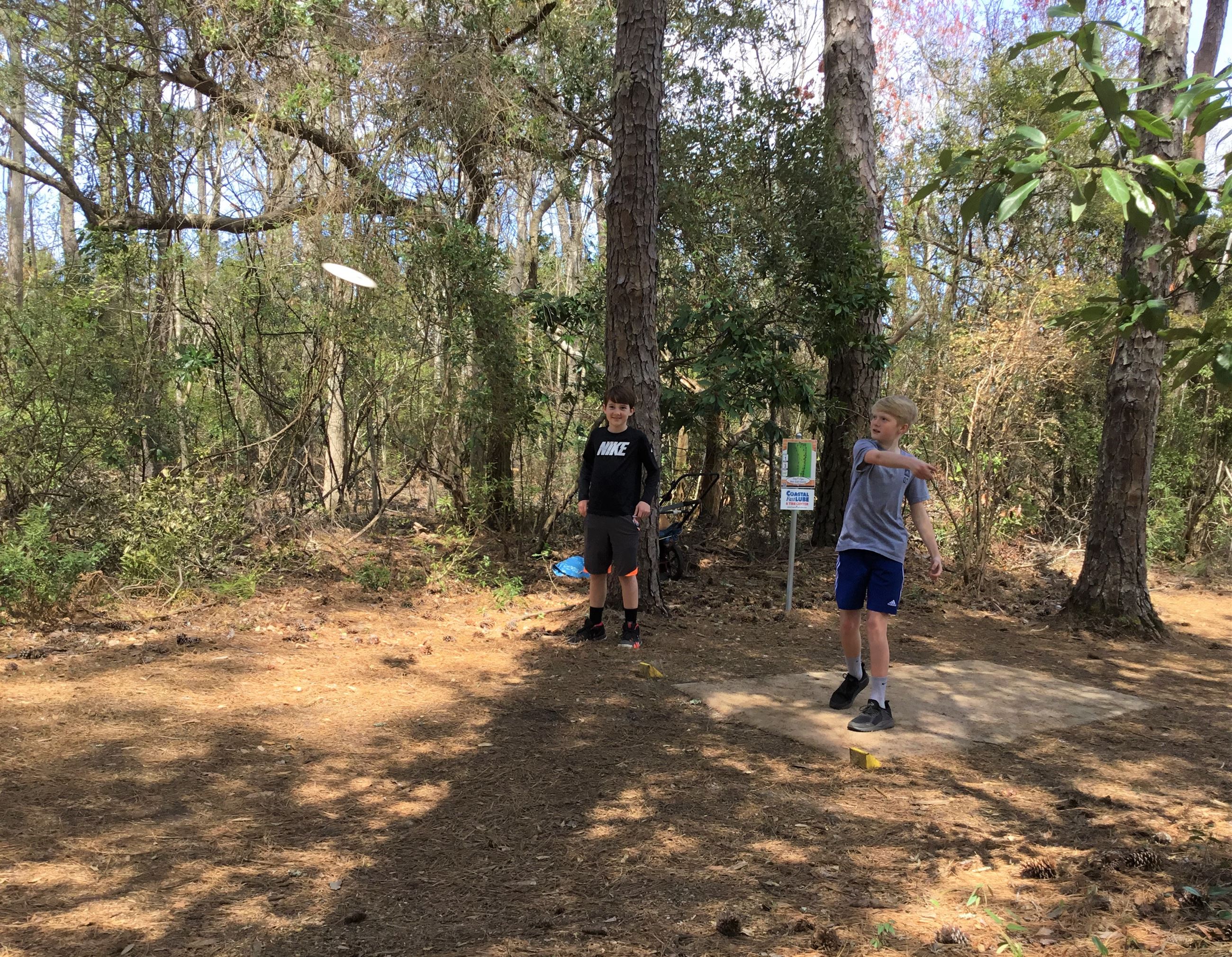 Kids playing disc golf