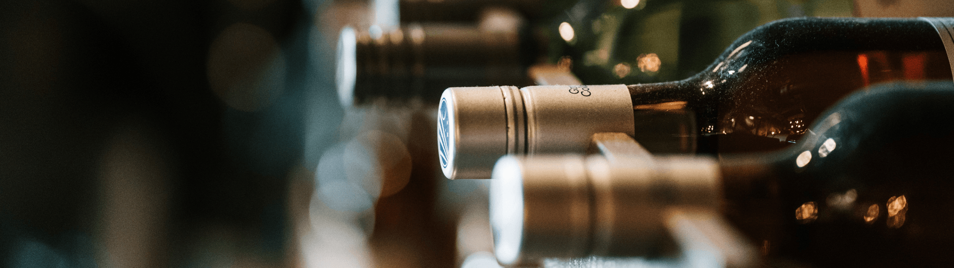 Blurred image of wine bottles laying on a shelf